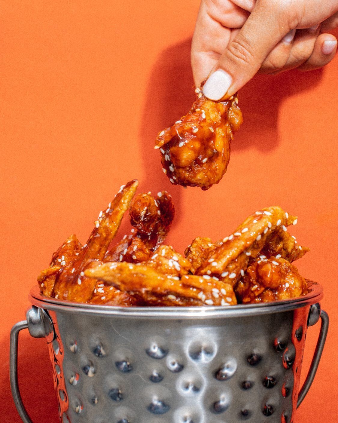 A bucket of glazed wings